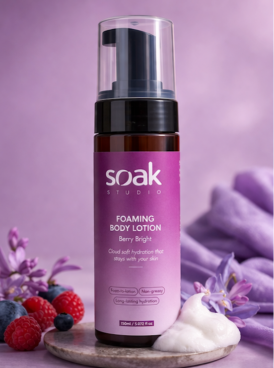 Soak Studio Foaming body lotion bottle with purple label on a purple background