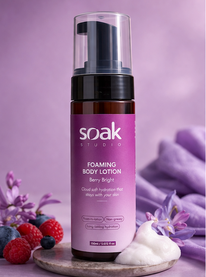 Soak Studio Foaming body lotion bottle with purple label on a purple background