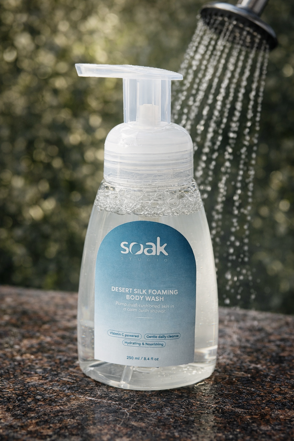 Soak Studio Desert Silk Foaming body wash bottle with a shower in the background