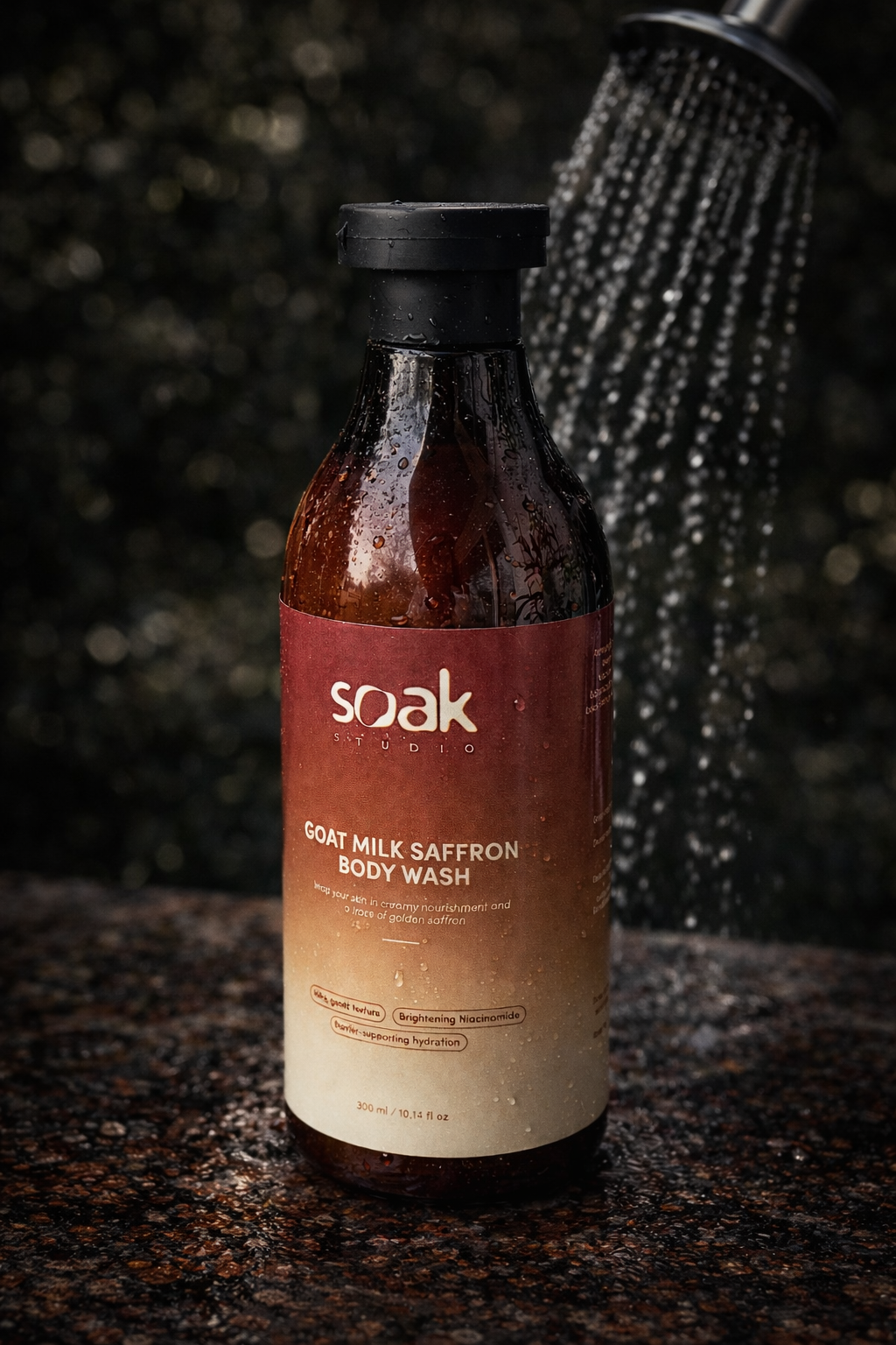 Bottle of Soak Saffron Body Wash with shower head in the background
