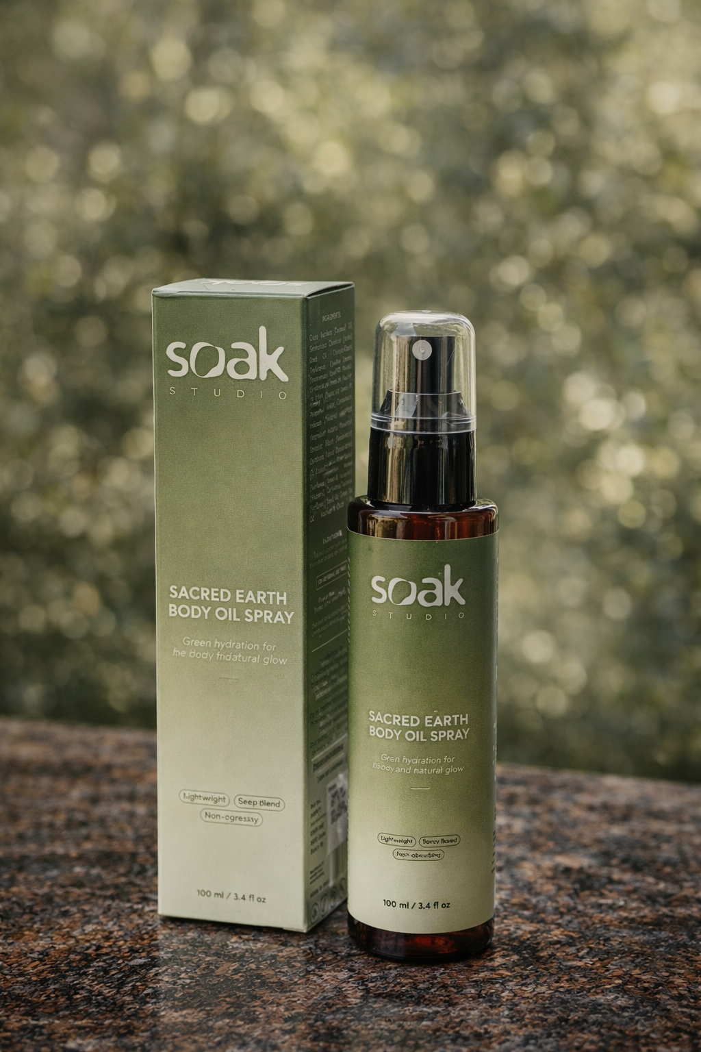 Soak Studio Sacred Earth Body oil spray on a blurred natural background