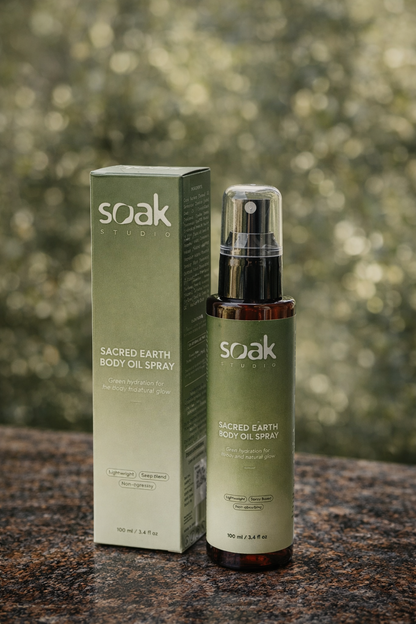 Soak Studio Sacred Earth Body oil spray on a blurred natural background