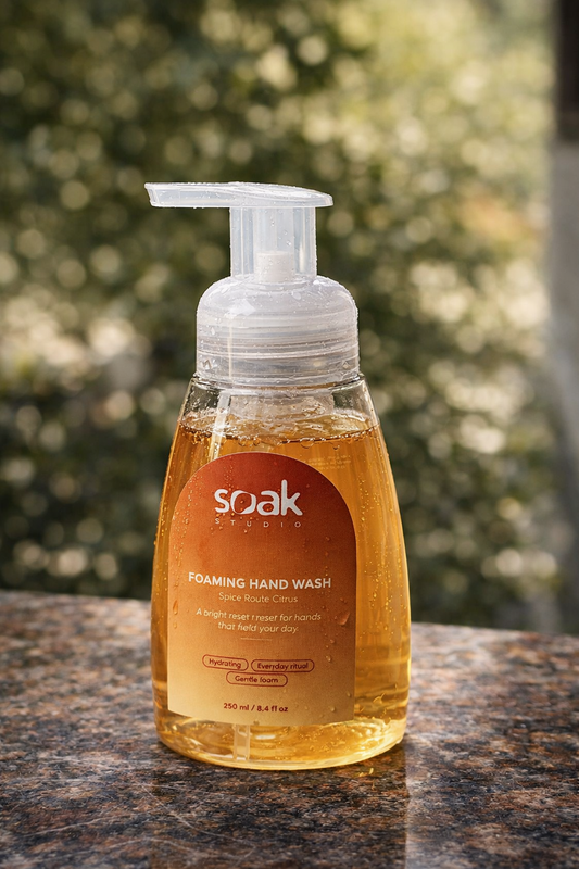 Soak Studio Spice Route Citrus Foaming hand wash bottle with a visible brand label on a blurred natural background